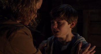 Movie still from “Goodnight Mommy” (2022), directed by Matt Sobel – A young boy and a young woman talking to each other; Close Up shot, Over the shoulder angle