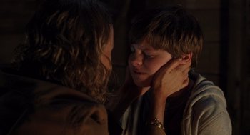 Movie still from “Goodnight Mommy” (2022), directed by Matt Sobel – A young boy and a young woman touching each other's face; Close Up shot, Over the shoulder angle