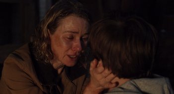 Movie still from “Goodnight Mommy” (2022), directed by Matt Sobel – A woman and a boy are touching each other's ear; Close Up shot, Over the shoulder angle