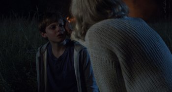 Movie still from “Goodnight Mommy” (2022), directed by Matt Sobel – A young boy looking at a woman in a sweater; Close Up shot, Over the shoulder angle