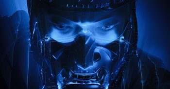 Movie still from “Gran Turismo” (2023), directed by Neill Blomkamp – A man's face in blue light; Extreme Close Up shot, Low angle