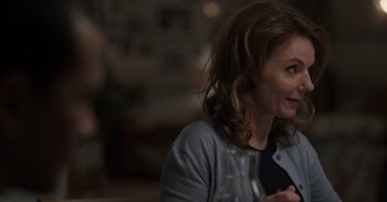 Movie still from “Gran Turismo” (2023), directed by Neill Blomkamp – A person sitting at a table; Close Up shot, Over the shoulder angle