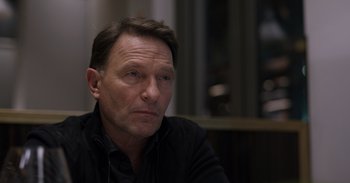 Movie still from “Gran Turismo” (2023), directed by Neill Blomkamp – A person wearing a black shirt; Close Up shot, Over the shoulder angle