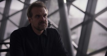 Movie still from “Gran Turismo” (2023), directed by Neill Blomkamp – A person wearing a black shirt; Close Up shot, Over the shoulder angle