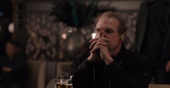 Movie still from “Gran Turismo” (2023), directed by Neill Blomkamp – A man sitting in front of a glass of beer; Close Up shot, Over the shoulder angle