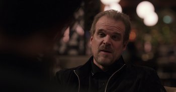 Movie still from “Gran Turismo” (2023), directed by Neill Blomkamp – A person wearing a jacket; Close Up shot, Over the shoulder angle