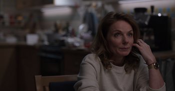 Movie still from “Gran Turismo” (2023), directed by Neill Blomkamp – A person sitting at a table; Close Up shot, Over the shoulder angle