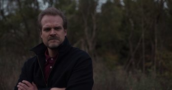 Movie still from “Gran Turismo” (2023), directed by Neill Blomkamp – A person wearing a jacket; Medium shot, Low angle