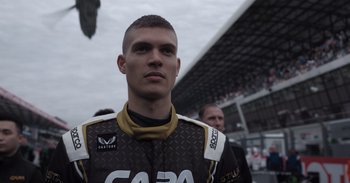 Movie still from “Gran Turismo” (2023), directed by Neill Blomkamp – A person wearing a racing suit; Close Up shot, Low angle