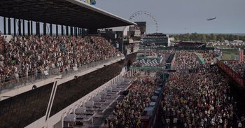 Movie still from “Gran Turismo” (2023), directed by Neill Blomkamp – A crowd of people watching a race on a race track; Extreme Wide shot, High angle