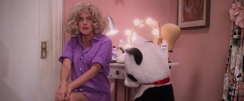 Movie still from “Grease” (1978), directed by Randal Kleiser – A woman sitting in front of a mirror next to a stuffed animal; Medium shot, Over the shoulder angle