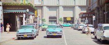 Movie still from “Grease” (1978), directed by Randal Kleiser – An image of cars parked on the side of the street; Extreme Wide shot, High angle