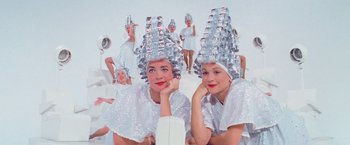 Movie still from “Grease” (1978), directed by Randal Kleiser – A group of women in silver hair curlers; Medium shot, Low angle