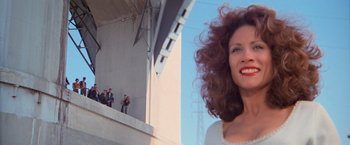 Movie still from “Grease” (1978), directed by Randal Kleiser – A person with curly brown hair; Medium shot, Low angle