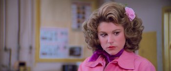 Movie still from “Grease” (1978), directed by Randal Kleiser – A person wearing a pink jacket; Close Up shot, Over the shoulder angle