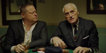 Movie still from “Green Book” (2018), directed by Peter Farrelly – Two men sitting at a table in a suit and tie; Medium shot, Over the shoulder angle