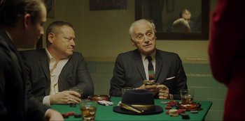 Movie still from “Green Book” (2018), directed by Peter Farrelly – Two men sitting at a table in front of cards; Medium shot, Over the shoulder angle