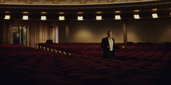 Movie still from “Green Book” (2018), directed by Peter Farrelly – A man in a suit standing in an empty theater; Extreme Wide shot, Low angle