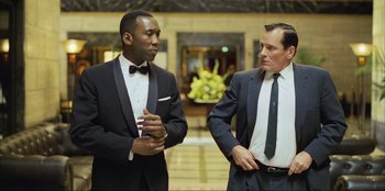 Movie still from “Green Book” (2018), directed by Peter Farrelly – A man in a suit and a man in a tie; Medium shot, Over the shoulder angle