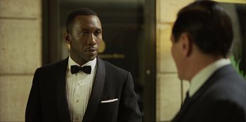 Movie still from “Green Book” (2018), directed by Peter Farrelly – A man in a tuxedo looking at a man in a suit in front of a mirror; Close Up shot, Over the shoulder angle