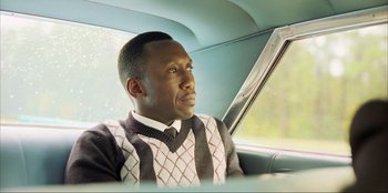 Movie still from “Green Book” (2018), directed by Peter Farrelly – A man sitting in the driver's seat of a car looking out the window; Close Up shot, Low angle