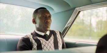 Movie still from “Green Book” (2018), directed by Peter Farrelly – A man sitting in the passenger seat of a car; Close Up shot, Low angle