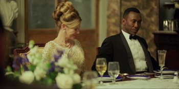 Movie still from “Green Book” (2018), directed by Peter Farrelly – A man and a woman sitting at a dinner table; Medium shot, Over the shoulder angle