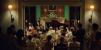 Movie still from “Green Book” (2018), directed by Peter Farrelly – A group of people sitting in front of a piano; Extreme Wide shot, High angle