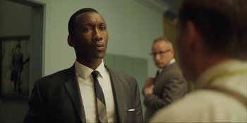 Movie still from “Green Book” (2018), directed by Peter Farrelly – A man in a suit and tie looking into a mirror; Close Up shot, Over the shoulder angle