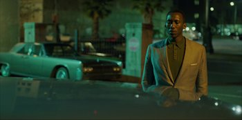 Movie still from “Green Book” (2018), directed by Peter Farrelly – A man standing in front of a car at night; Medium shot, Over the shoulder angle