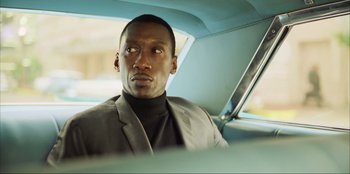Movie still from “Green Book” (2018), directed by Peter Farrelly – A man sitting in the back seat of a car; Close Up shot, Low angle