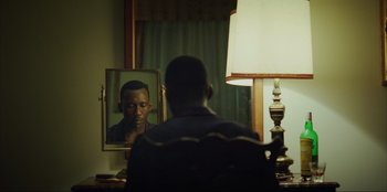 Movie still from “Green Book” (2018), directed by Peter Farrelly – A man sitting in front of a mirror looking at himself in the mirror; Medium shot, Over the shoulder angle