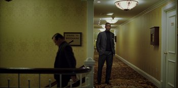 Movie still from “Green Book” (2018), directed by Peter Farrelly – A man in a suit standing in a hotel hallway; Wide shot, Low angle