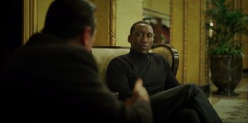 Movie still from “Green Book” (2018), directed by Peter Farrelly – A man sitting on top of a couch next to another man; Medium shot, Over the shoulder angle