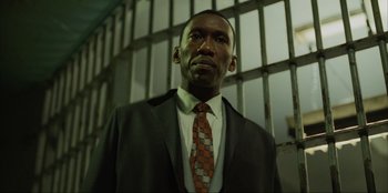 Movie still from “Green Book” (2018), directed by Peter Farrelly – A man wearing a suit and tie in a jail cell; Close Up shot, Low angle