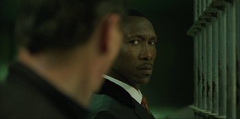 Movie still from “Green Book” (2018), directed by Peter Farrelly – A man in a suit and tie looking into the distance; Close Up shot, Over the shoulder angle