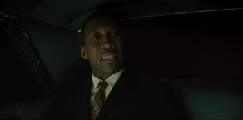 Movie still from “Green Book” (2018), directed by Peter Farrelly – A man wearing a suit and tie in a car; Close Up shot, Over the shoulder angle