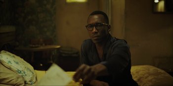 Movie still from “Green Book” (2018), directed by Peter Farrelly – A man sitting at a table with papers in front of him; Close Up shot, Over the shoulder angle