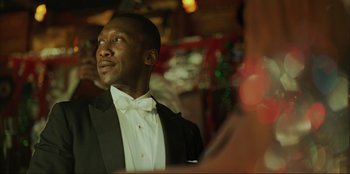 Movie still from “Green Book” (2018), directed by Peter Farrelly – A man in a tuxedo is looking up at the ceiling; Close Up shot, Low angle