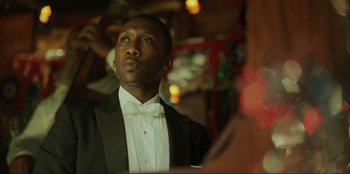 Movie still from “Green Book” (2018), directed by Peter Farrelly – A man in a tuxedo is looking up at the ceiling; Close Up shot, Low angle