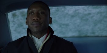 Movie still from “Green Book” (2018), directed by Peter Farrelly – A person wearing a suit and tie; Close Up shot, Low angle