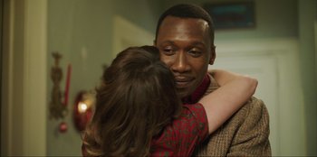 Movie still from “Green Book” (2018), directed by Peter Farrelly – A man and a woman hugging each other in front of a wall; Close Up shot, Over the shoulder angle