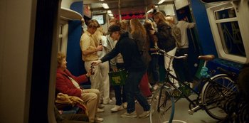Movie still from “Another Round” (2020), directed by Thomas Vinterberg – A group of people riding on a subway train; Wide shot, High angle