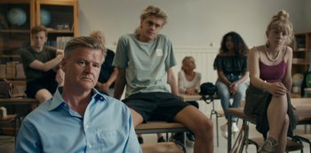 Movie still from “Another Round” (2020), directed by Thomas Vinterberg – A group of people sitting in a room; Medium shot, Over the shoulder angle