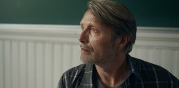 Movie still from “Another Round” (2020), directed by Thomas Vinterberg – A person wearing a plaid shirt looking to the side; Close Up shot, Over the shoulder angle