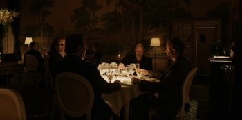 Movie still from “Another Round” (2020), directed by Thomas Vinterberg – A group of people sitting around a table; Wide shot, High angle