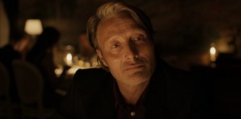 Movie still from “Another Round” (2020), directed by Thomas Vinterberg – Mads mikkelsen wearing a suit; Close Up shot, Low angle