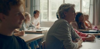 Movie still from “Another Round” (2020), directed by Thomas Vinterberg – A group of people sitting at tables in a room; Medium shot, Over the shoulder angle