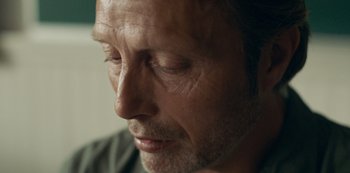 Movie still from “Another Round” (2020), directed by Thomas Vinterberg – A man's face with his eyes closed; Extreme Close Up shot, Over the shoulder angle