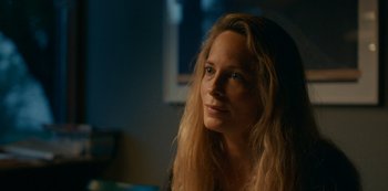 Movie still from “Another Round” (2020), directed by Thomas Vinterberg – A woman with long blonde hair sitting in front of a window; Close Up shot, Over the shoulder angle